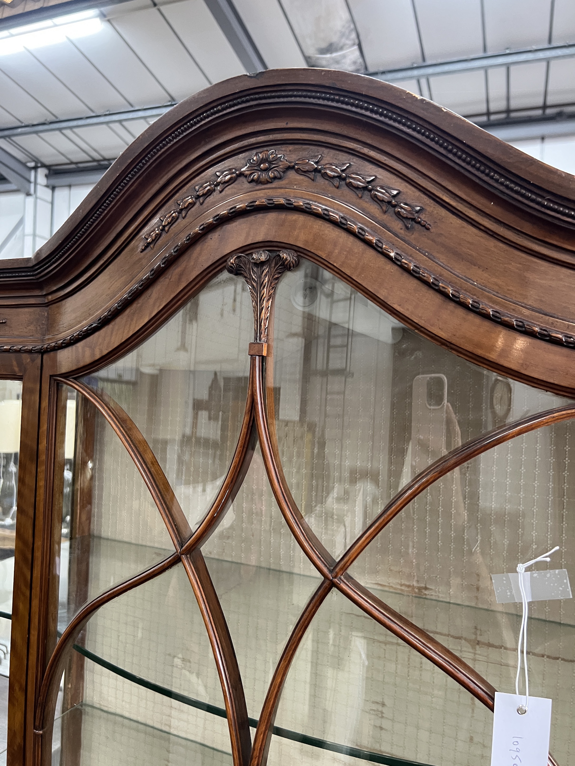 A 1920's Sheraton revival satinwood bowfront display cabinet, width 114cm, depth 42cm, height 211cm